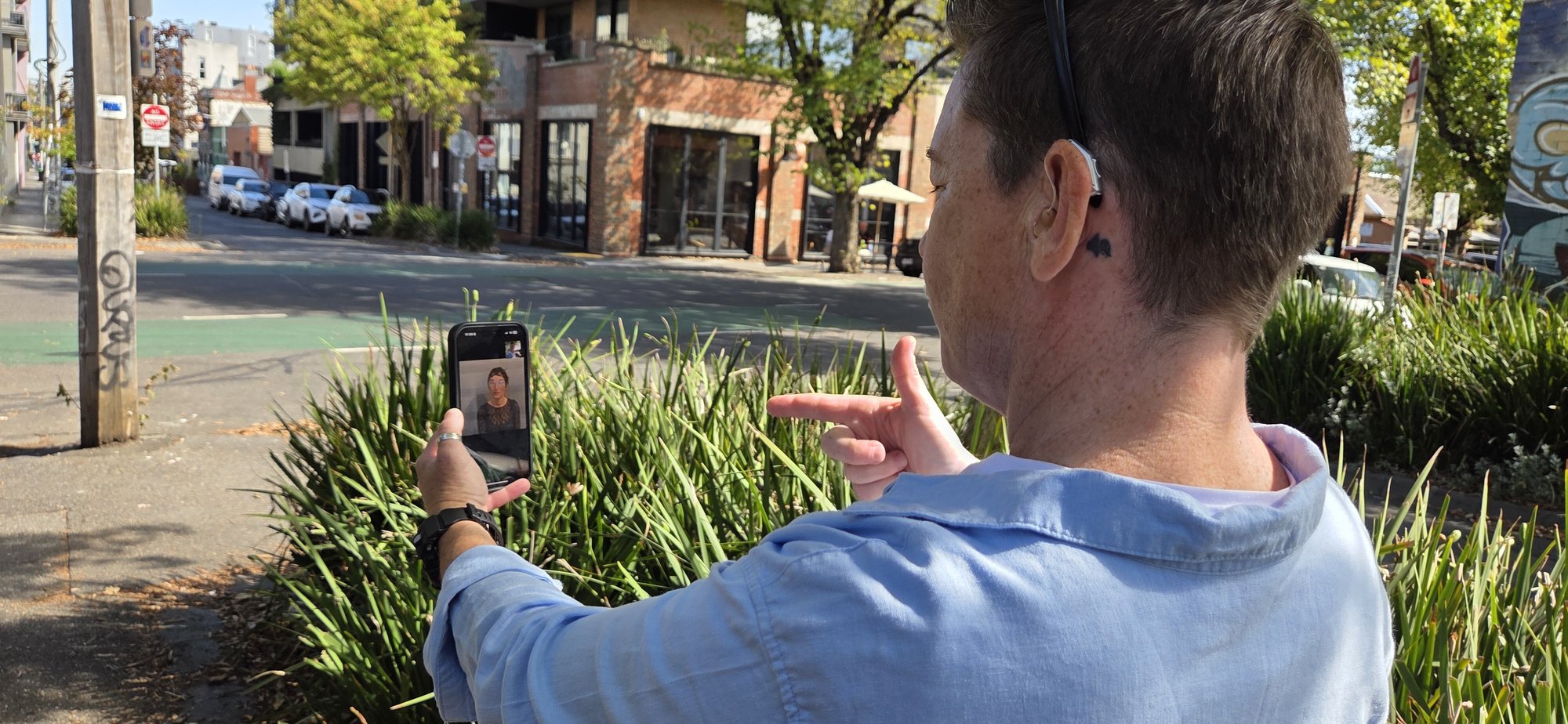 A Convo interpreter appears on the smartphone screen while the Deaf person is talking on the phone using Convo Now. A Convo interpreter appears on the smartphone screen while the Deaf person is talking on the phone using Convo Now.